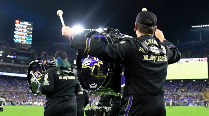 Baltimore Ravens marching band run on the field during a game